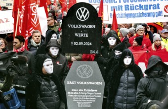 A symbolic VW coffin is carried by Volkswagen employees to the collective bargaining negotiations