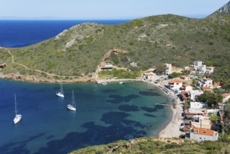 A sheltered bay with sailing boats and a small village surrounded by green hills, Porto Kagio,