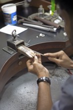 Sri Lankan man cutting a ring, gemstone cutting workshop in Kandy, Central Province, Sri Lanka,