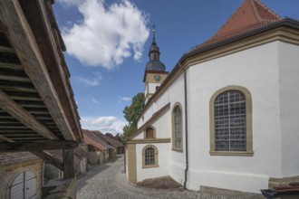 Former so-called Kirchgaden, barns, on the right the Protestant St John's Church in the historic