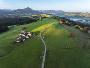 Mountain range near village Wertach, view to mt. Gruenten, sunrise, fog in valley, traditional