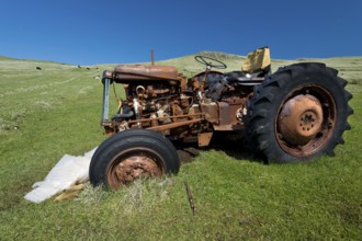 Old rusty tractor standing in a meadow, Mykines, Útoyggjar, Faroe Islands, Denmark, Europe