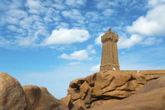 Lighthouse resting majestically on massive rocks under a clear sky, Phare de Men Ruz, Ploumanac'h,