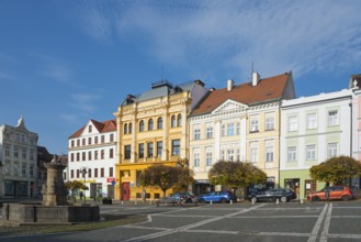 Colourful neoclassical townhouses line the square under a clear sky, fountain, Ceská Lípa, Bohemian