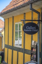 Gallery sign at yellow half-timbered house in Gudhjem, Bornholm, Baltic Sea, Denmark, Scandinavia,