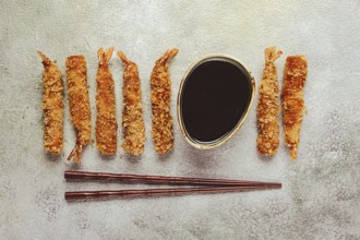 Fried shrimp, peeled in tempura, soy sauce, close-up