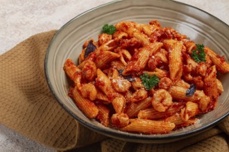 Penne pasta, with shrimp in tomato sauce, close-up, no people