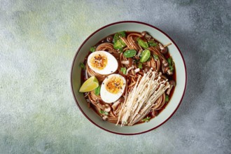 Soba, buckwheat noodles, with enoki mushrooms, shimeji and boiled egg, top view, homemade, no