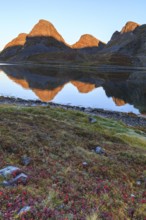 Reflection of Bergen in fjord, morning light, autumn, Nordkinn Peninsula, Finnmark, Norway, Europe