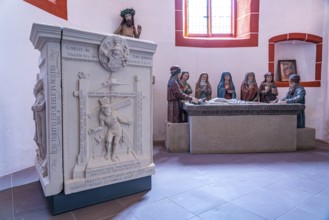 Stone relief of Christ in the winepress and burial group in the Catholic parish church of St Martin