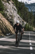 Road bike rider in spring between Lechtal and Tannheimer Tal in front of picturesque scenery of the