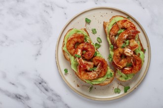 Sandwiches with avocado and caramelized shrimp, micro-greens, breakfast, on a plate, top view,