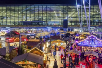 Christmas market at the airport in the evening, market stalls decorated for Christmas in front of