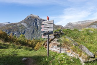 Signpost at Alpe Homlongsætra above the Geirangerfjord, traditional summer farm, Geirangerfjord,