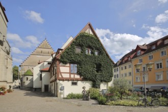 Town hall with ivy and sculpture of a woman in traditional traditional costume, Überlingen,