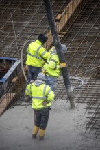 Construction site, concreting, the foundation of a building is concreted, the concrete is pumped