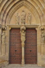 Sculptures on the Virgin Mary portal with tympanum and Archangel Michael, Gothic church portal,