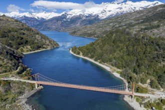 Aerial view of famous orange suspension bridge Puente General Carrera, bridge spans the connection