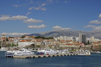 Passenger ferries and parts of the city centre, skyscrapers and mountains, Split, Dalmatia,