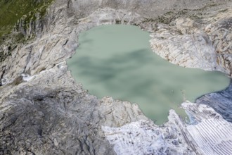 Drone shot of melting Rhone glacier, glacial lake, source of Rhone river, Switzerland, Europe