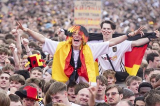 Football fans in the fan zone at the Brandenburg Tor during the quarter-final match between Germany