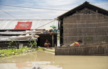 Morigaon, India. 4 July 2024. Residents in their flooded house, in a flood affected village in