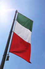 Italian national flag against a blue sky