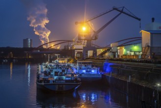 Cargo ships and cranes in Essen city harbour, on the Rhine-Herne Canal, motorway bridge of the A42