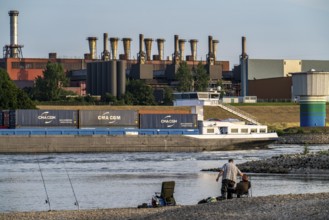 Industrial backdrop of the ThyssenKrupp Steel steelworks in Bruckhausen, on the Rhine, anglers in a