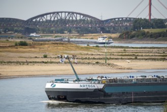 The Rhine with extremely low water, here near Duisburg-Beeckerwerth, cargo ships only travelling