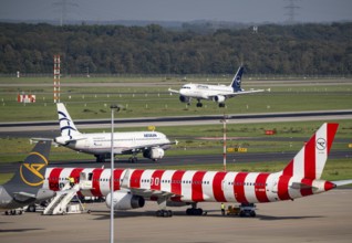 Düsseldorf Airport, Lufthansa Airbus on landing, Aegean Airlines Airbus A320-200 on the taxiway,