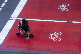 E-scooter, e-scooter on bicycle lane, parking area for cyclists at a traffic light crossing, marked