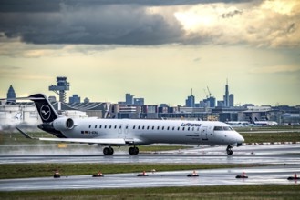 Lufthansa Bombardier CRJ-900, D-ACNJ, taking off on the western runway, skyline of Frankfurt city