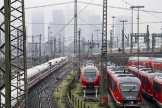 Railway tracks with regional and long-distance trains, ICE, after freezing rain, in front of