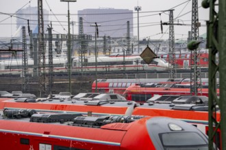 Railway tracks with regional trains and long-distance trains, ICE, after freezing rain, in front of