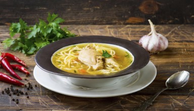 Food, a plate of chicken soup with noodles on a wooden table, AI generated, AI generated