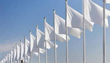 Symbol photo, a long row of white flags fluttering on flagpoles in the wind, AI generated, AI