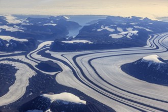 Aerial view of glaciers, glacier tongues and icy mountains on the coast, sunny, East Greenland,