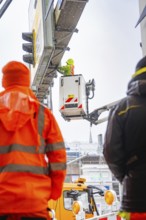 Construction worker working at a great height with a crane in the rain on a building site, Hermann