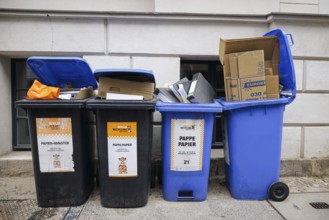 Symbolic photo. Overfilled paper bins on a street in Berlin Mitte. Berlin, 04.06.2024