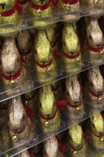 Display in shelf of wholesale of chocolate Easter bunnies Easter bunnies in multicoloured chocolate