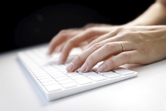 Hands typing on a keyboard in Berlin, 09/08/2024