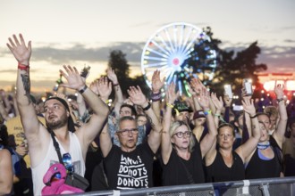 Festival visitors illuminate the site with mobile phone lights at the Highfield Festival on Friday,