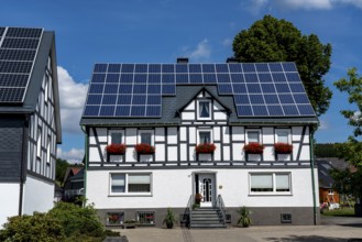 Half-timbered house with a solar roof, solar modules on the pitched roof, near Bad Berleburg, North