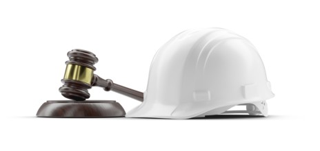 White hard hat and gavel isolated on a white background