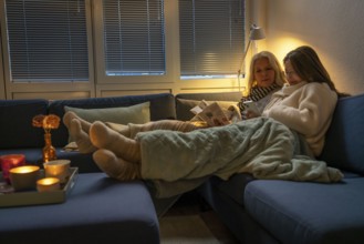 Symbolic image energy saving, cold winter, energy crisis, cold flat, mother and daughter lying on