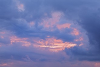 Blue and pink coloured cloudy sky at sunset, Switzerland, Europe