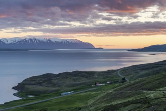 Snow-covered mountains, road and farm, sunrise over Eyjafjörður or Eyjarfjörður or Eyjafjördur,