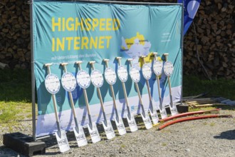 Advertising banner for high-speed Internet with shovels lined up and piles of wood in the