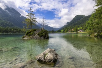 Hintersee near Ramsau with clear green water, surrounded by forests and mountains under a cloudy